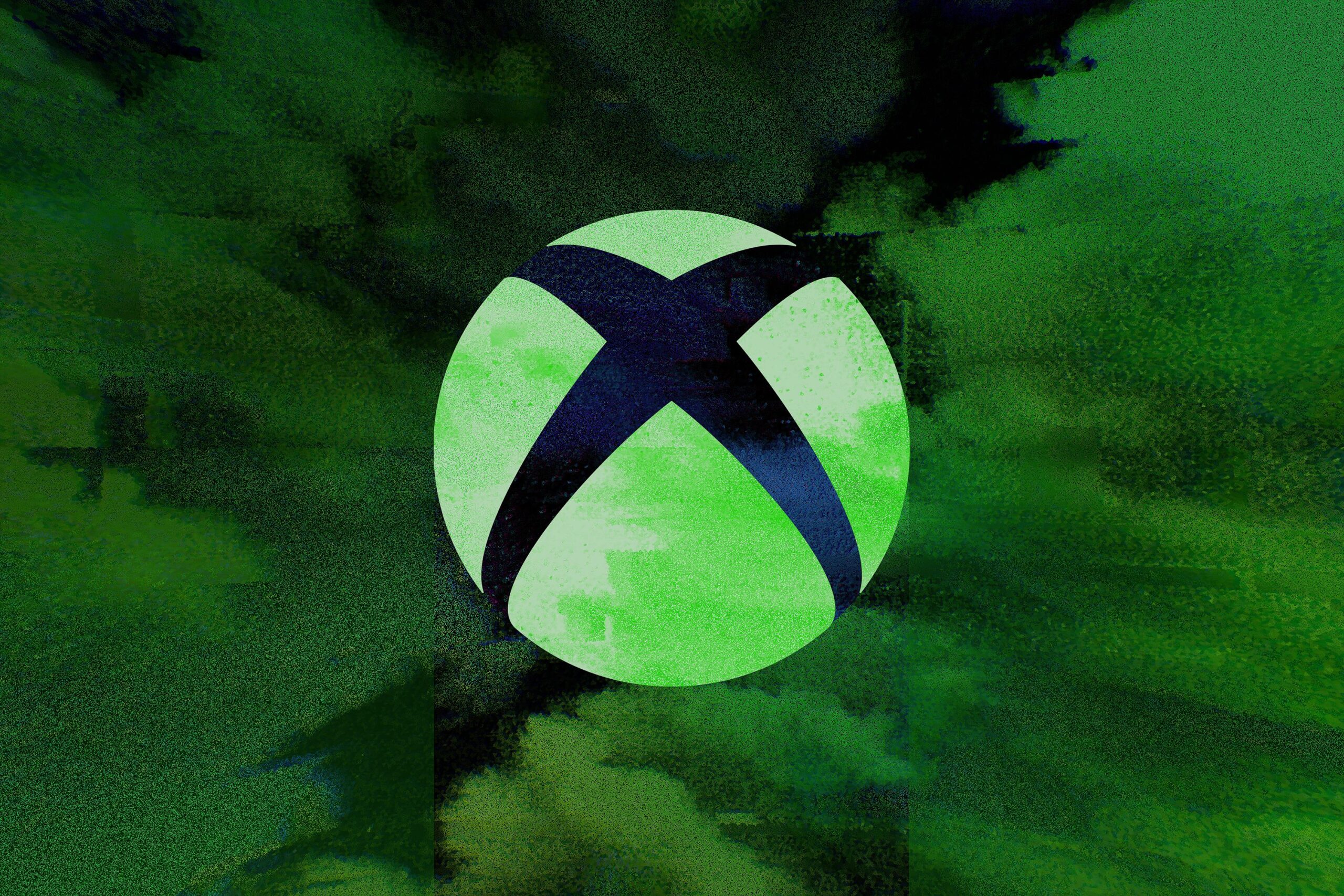 Logotipo do Xbox brilhando em verde sobre uma superfície preta.
